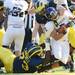 Michigan defensive tackle William Campbell and linebacker Jake Ryan tackle Northwestern quarterback Kain Colter during the fourth quarter at Michigan Stadium on Saturday. Melanie Maxwell I AnnArbor.com